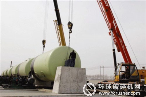 圖為技術工人正在安裝球磨機設備